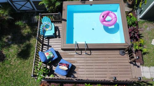 an overhead view of a pool with two chairs and an inflatable at Tampa Jungalow- Pool Oasis in Tampa