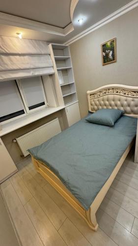 a bedroom with a bed in a room with shelves at APARTMENT PREMIUM VIP in Berdychiv
