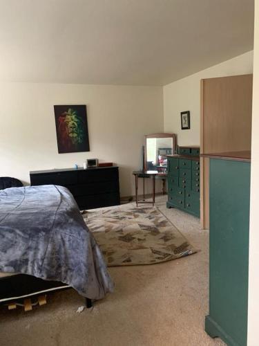 a bedroom with a bed and a dresser and a mirror at Cedar River 1 BR in 4 BR HOUSE in Renton