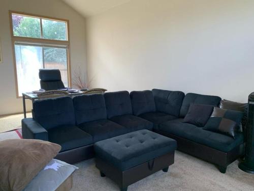 a living room with a blue couch and a chair at Cedar River 1 BR in 4 BR HOUSE in Renton