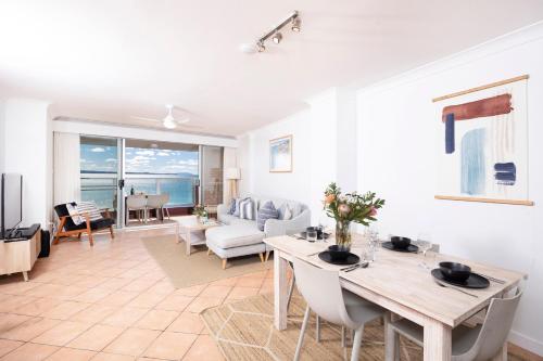a living room with a table and a couch at El Sandi, Unit 10, 14-18 North Street in Forster
