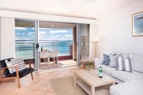 a living room with a view of the ocean at El Sandi, Unit 10, 14-18 North Street in Forster