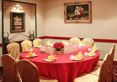 a red table with chairs and a red table cloth at Grand Palace Hotel in Miri