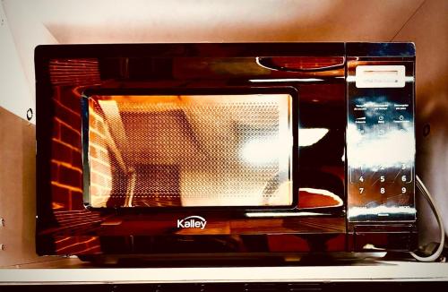 a microwave oven sitting on top of a table at Cozy Industrial Envigado loft in Envigado