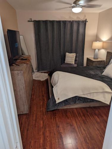 a bedroom with a bed and a television in it at STADIUM LUXURY - CONDO for 4 STEPS AWAY FROM SOFI in Inglewood