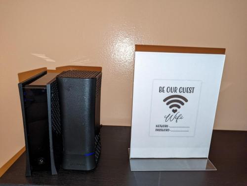 a black modem and a box on a table at STADIUM LUXURY - CONDO for 4 STEPS AWAY FROM SOFI in Inglewood