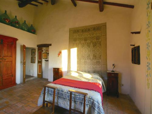 a bedroom with a bed and two chairs in it at Cottage with Lake Views in San Savino