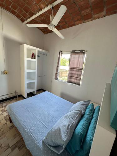 a bedroom with a bed and a ceiling fan at Casa Arena in Lo de Marcos