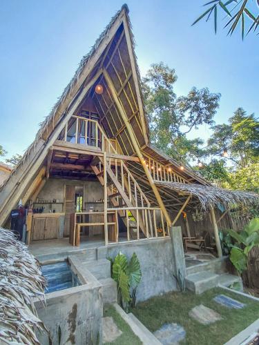 a large house with a thatched roof at Casa Kalikasan 2 in El Nido