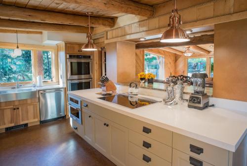 a kitchen with white countertops and wooden ceilings at Jackson Hole Hideout in Wilson