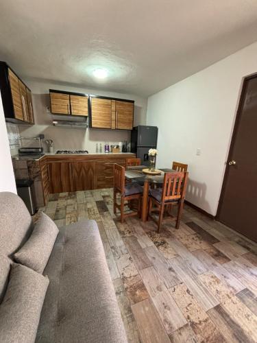 a kitchen with a table and chairs in a room at Casa SAMA 11 in Oaxaca City