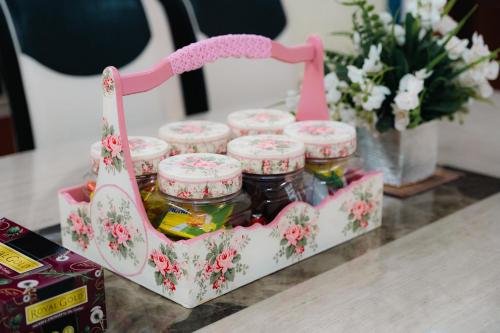 a basket filled with jars of jam on a table at Villa Cinta Jasmeen in Kuala Kangsar