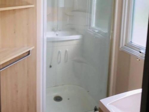 a bathroom with a shower and a sink at Mobil-home confortable avec terrasse pour 4 personnes - API-1-52-413 in Massillargues-Attuech