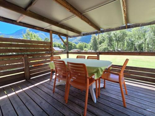 a table and chairs on a deck with a view at Mobil-home 3 chambres avec terrasse à Valbonnais - API-1-52-473 in Valbonnais
