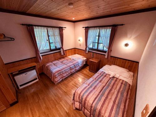 an overhead view of a bedroom with two beds and windows at Ringo Lodge Hakuba in Hakuba