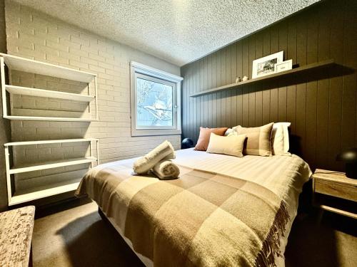 a bedroom with a large bed in a room at Enzian 3 AMS Mt Buller in Mount Buller