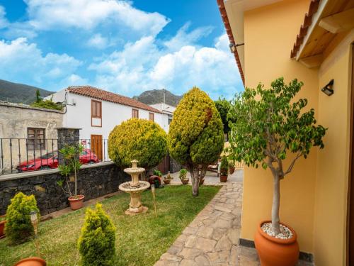 a courtyard of a house with trees and plants at Villa in Tenerife with Pool and Sea Views in Teno Alto