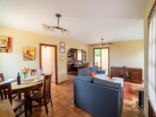 a living room with a blue couch and a table at Villa in Tenerife with Pool and Sea Views in Teno Alto