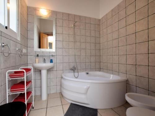 a bathroom with a white tub and a sink at Villa in Arenas with Sea Views and Private Pool in Arenas