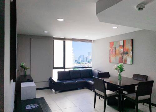 a living room with a couch and a table at Depa Puerto Santana,AC,WIFI,Bares,Restaurante,segurida 24-7 in Guayaquil