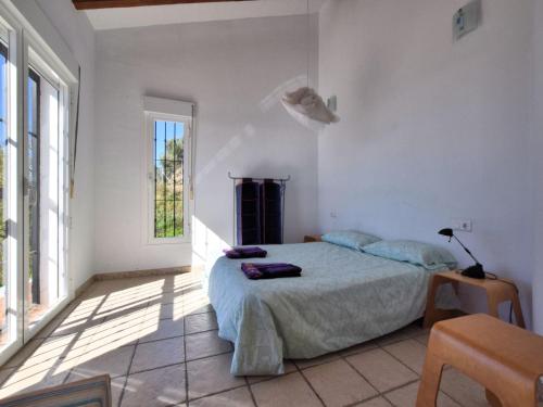 a white bedroom with a bed and a window at Villa in Arenas with Sea Views and Private Pool in Arenas