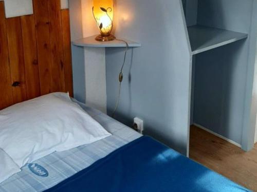 a bedroom with a bed with a light on it at Chalet 3 chambres avec terrasse pour 5 personnes - API-1-52-617 in Rives