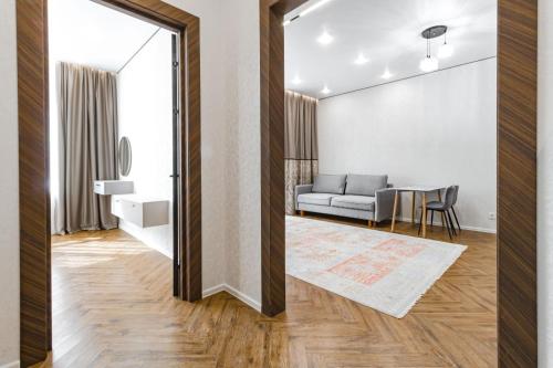 a living room with a couch and a table at GreenLine Atmosfera luxe 2 bedroom apartment in Zhezdi
