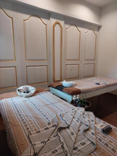 a room with two beds in a room at Ln House Chiang Mai in Chiang Mai