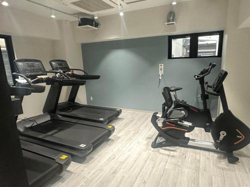 a gym with two exercise bikes in a room at HOTEL WINDS ASAKUSA Capsule Inn 浅草 in Tokyo