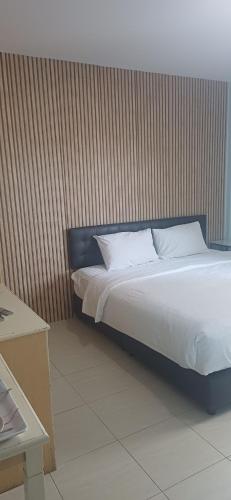 a bed with white sheets and pillows in a room at AT home hotel in Hua Hin