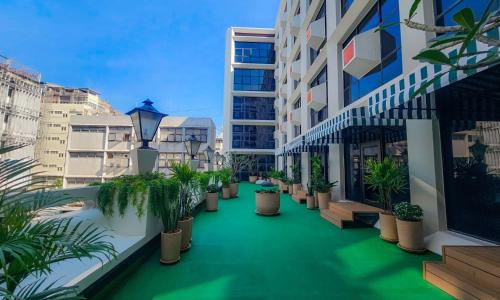 an apartment courtyard with potted plants and buildings at Lub d Bangkok Chinatown - Steps from Sam Yod MRT Station in Bangkok