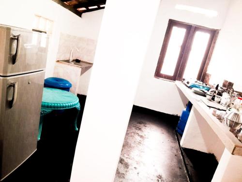 a kitchen with a refrigerator and a counter with a window at Aqua Bliss Resort & Villa Bentota in Bentota