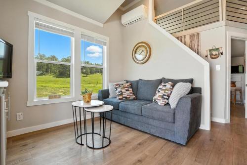 a living room with a couch and a table at The Fluffy Cow - BRAND NEW 1 BD CABIN in Custer
