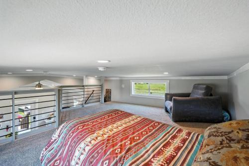 a bedroom with a bed and a couch and a chair at The Fluffy Cow - BRAND NEW 1 BD CABIN in Custer