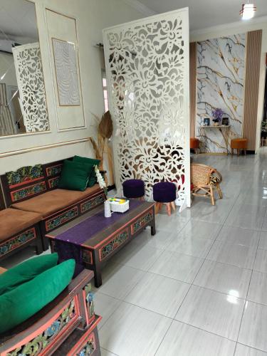 a living room with a couch and a table at Taman Salak Homestay -5BR Entire House in Madiun
