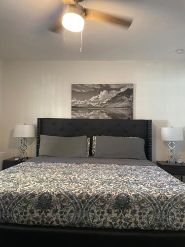 a bedroom with a bed and a ceiling fan at Little Carnation in St. Augustine