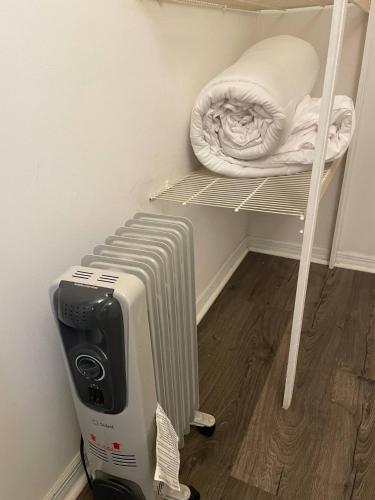 a room with a radiator and a mattress on a shelf at Little Carnation in St. Augustine