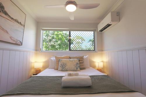 a bed in a small room with a window at Ingenia Holidays Townsville in Townsville