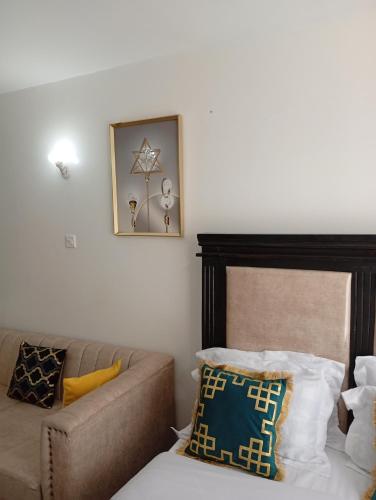 a living room with a couch and a bed at ONeal Prime Suites - Furnished Studio apartments in Nairobi Near JKIA & SGR in Nairobi