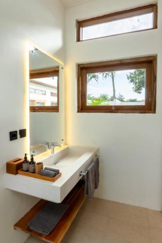 a bathroom with a sink and a mirror at 2Bedrooms Bright&Modern Villa near Balangan Beach! in Jimbaran