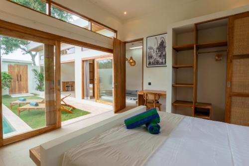 a bedroom with a large bed and a large window at 2Bedrooms Bright&Modern Villa near Balangan Beach! in Jimbaran