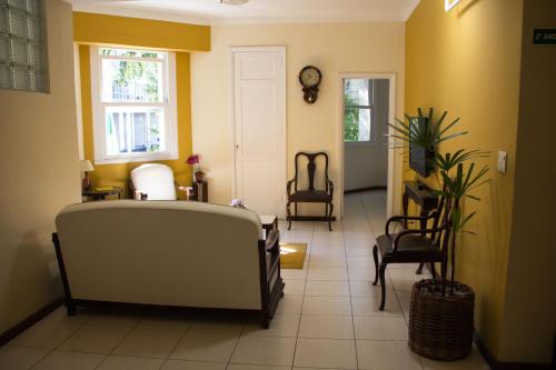 a hallway with chairs and a clock on the wall at Hotel Carioca in Rio de Janeiro