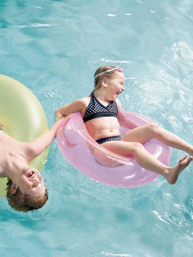 a young girl in a raft in a swimming pool at Country Inn & Suites by Radisson, Billings, MT in Billings