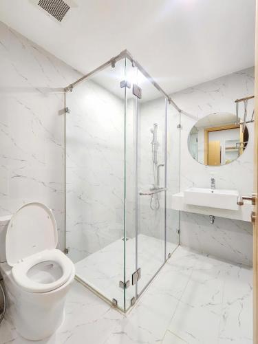 a bathroom with a shower and a toilet and a sink at Căn hộ TMS Pullman cao cấp Studio có ban công view biển - Golden Wave Homestay in Quy Nhon