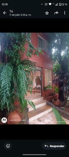 a screen shot of a house with a garden at Sweet Guest House in Puerto Iguazú