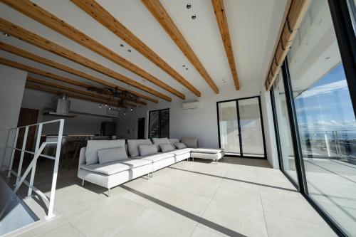 a living room with a white couch and large windows at theView 三浦市晴海町 in Miura