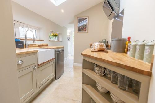 a kitchen with a sink and a counter top at Cozy Cottage, Wrington in Wrington