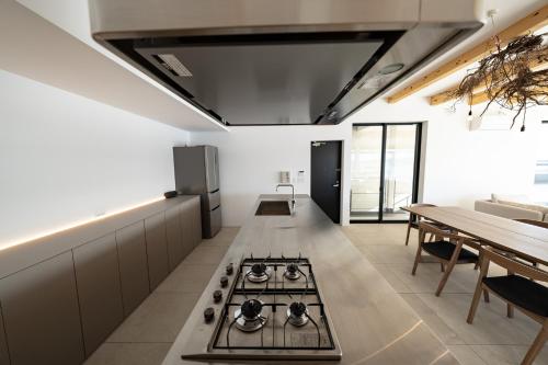 a kitchen with a stove top oven in a room at theView 三浦市晴海町 in Miura