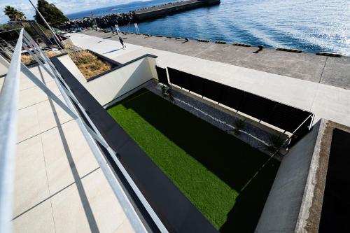 an external view of a building with a lawn at theView 三浦市晴海町 in Miura