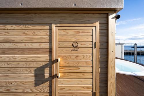 a wooden garage door with a tub in the background at theView 三浦市晴海町 in Miura